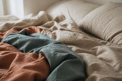 Rumpled linen and terracotta bedsheets